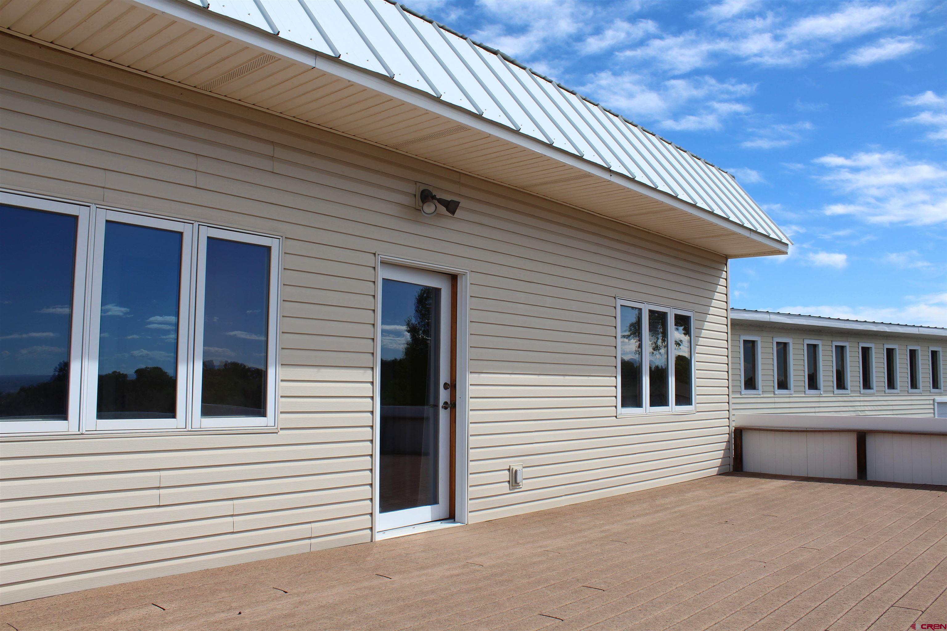 16754 Bull Mesa Road Cedaredge, CO 81413 - Photo 23 of 35 a view of a house with a balcony