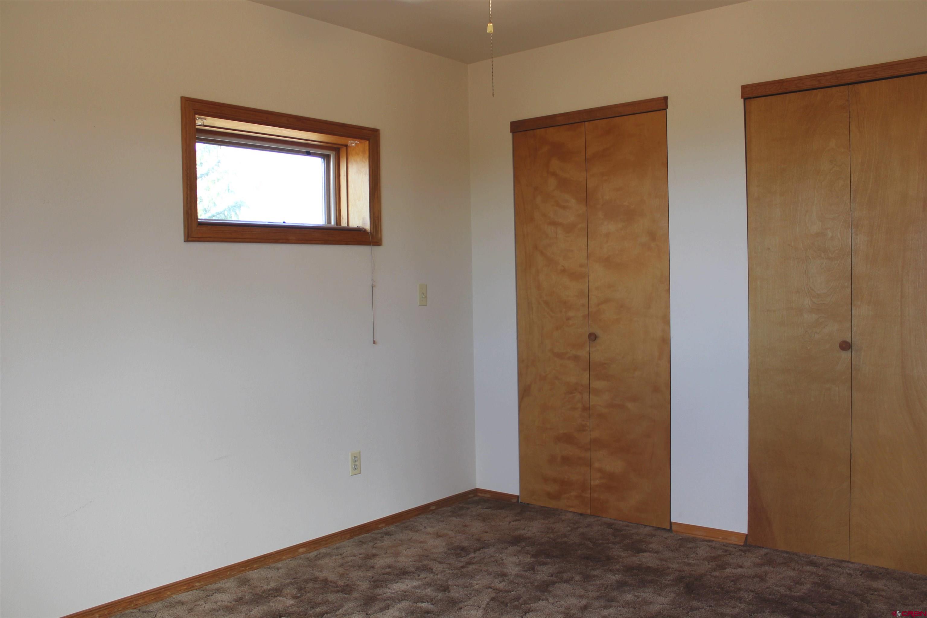 16754 Bull Mesa Road Cedaredge, CO 81413 - Photo 26 of 35 an empty room with windows