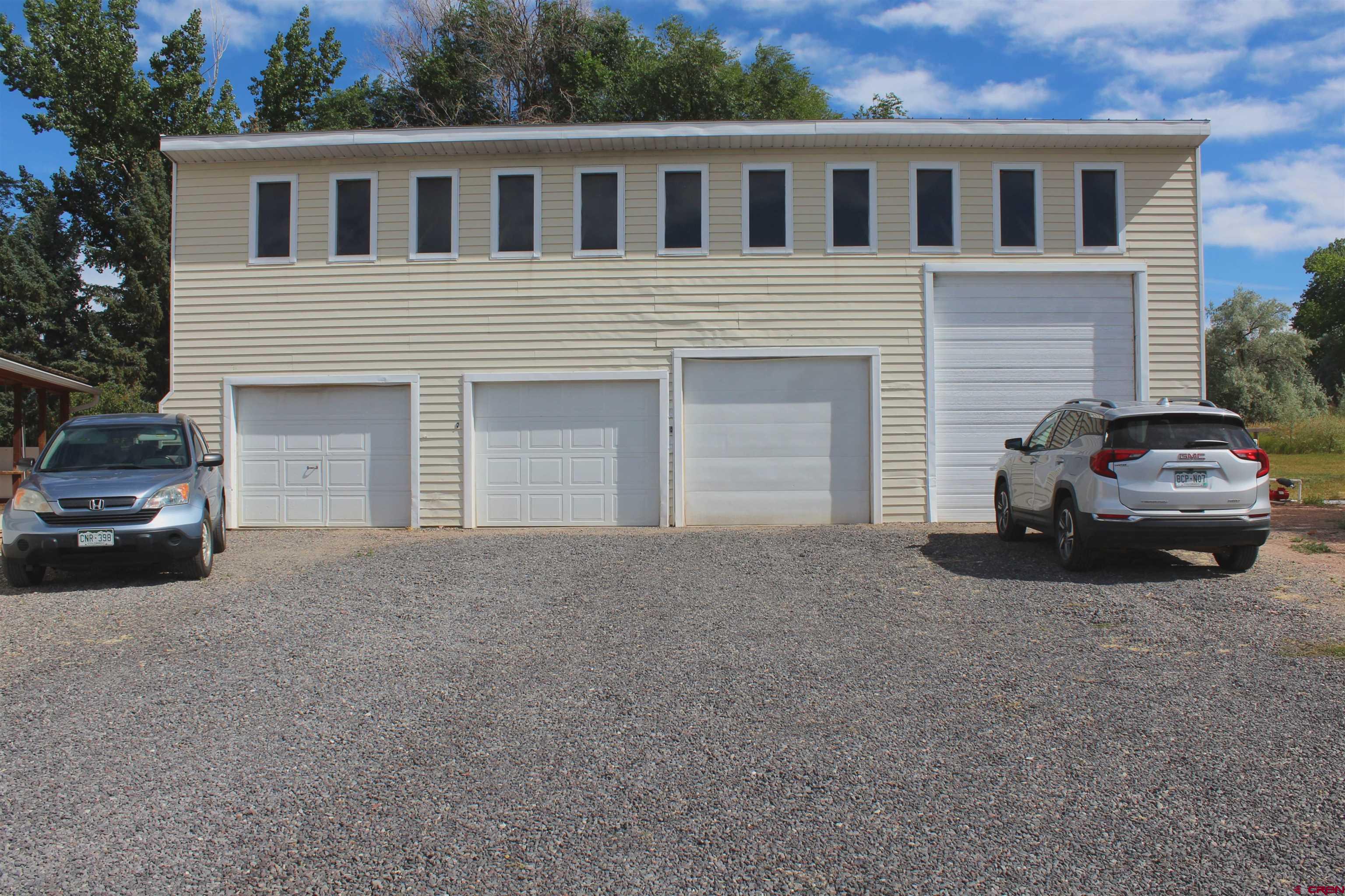 16754 Bull Mesa Road Cedaredge, CO 81413 - Photo 30 of 35 a car parked in front of a house
