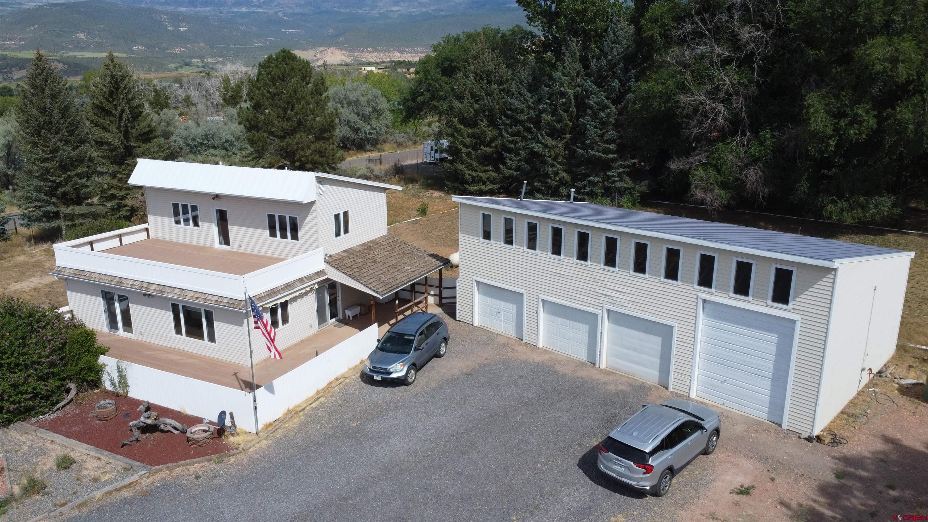 16754 Bull Mesa Road Cedaredge, CO 81413 - Photo 3 of 35 an aerial view of a house with a yard