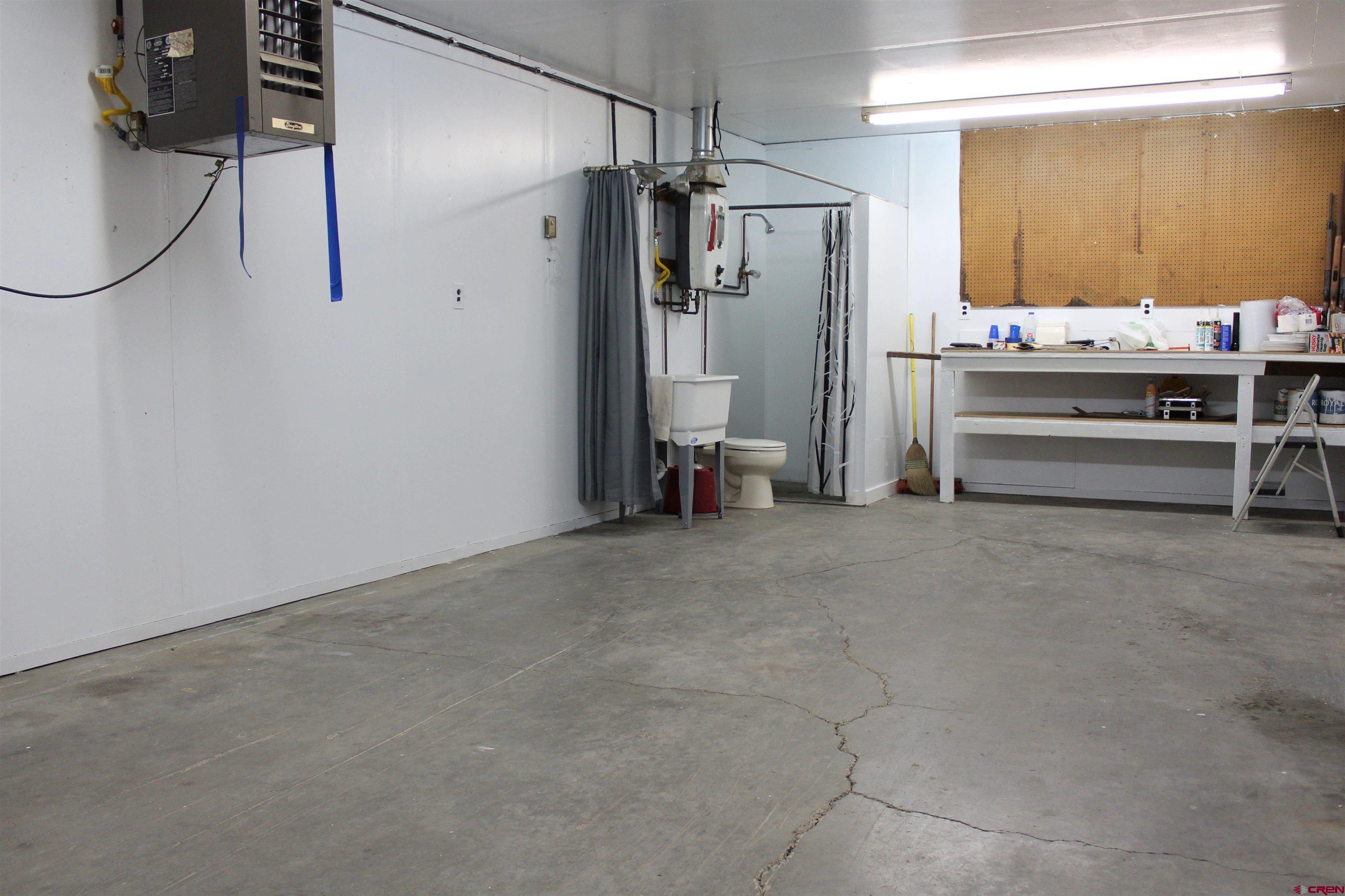 16754 Bull Mesa Road Cedaredge, CO 81413 - Photo 33 of 35 a room with stainless steel appliances kitchen island granite countertop furniture a refrigerator and a window