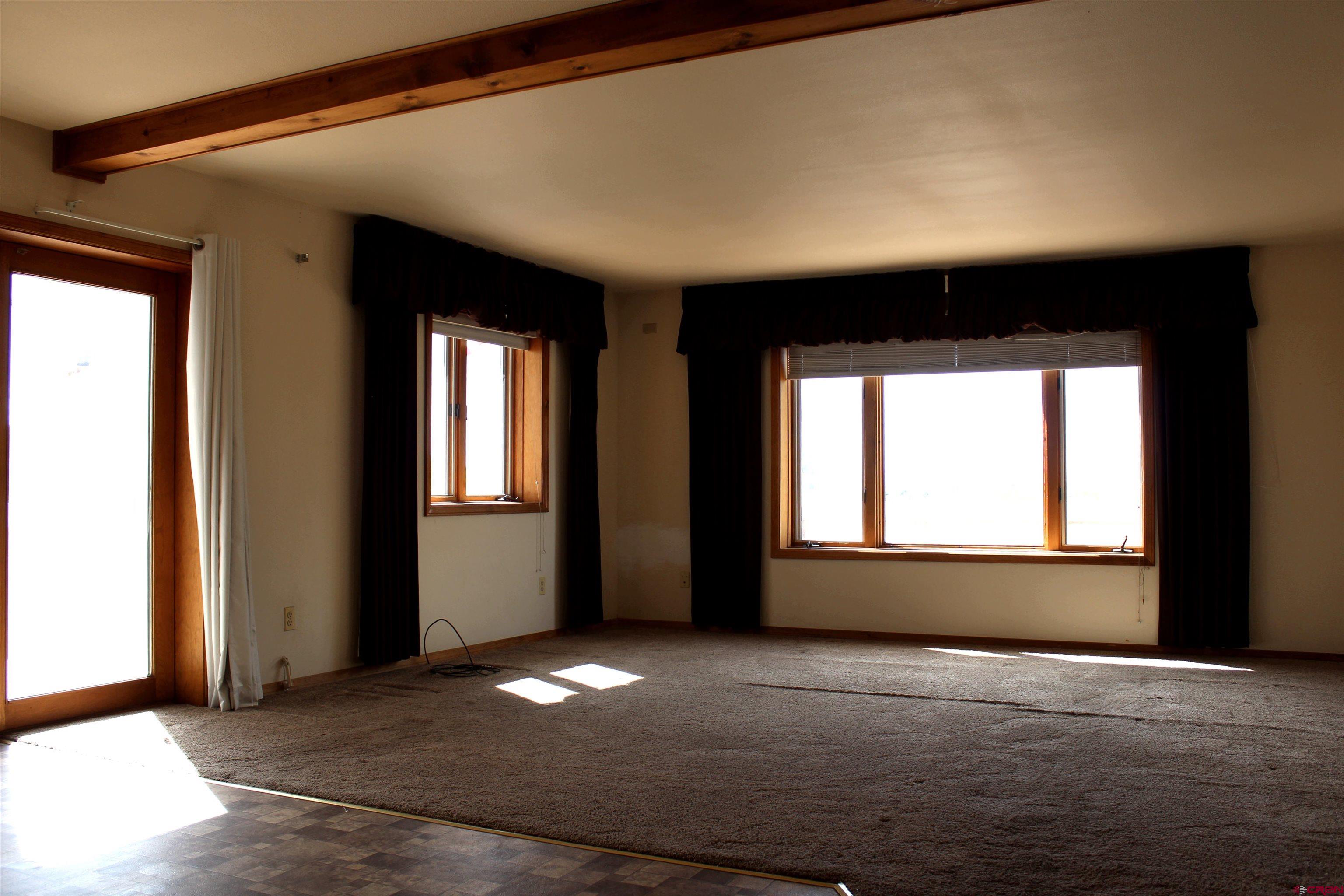 16754 Bull Mesa Road Cedaredge, CO 81413 - Photo 9 of 35 a view of empty room with window