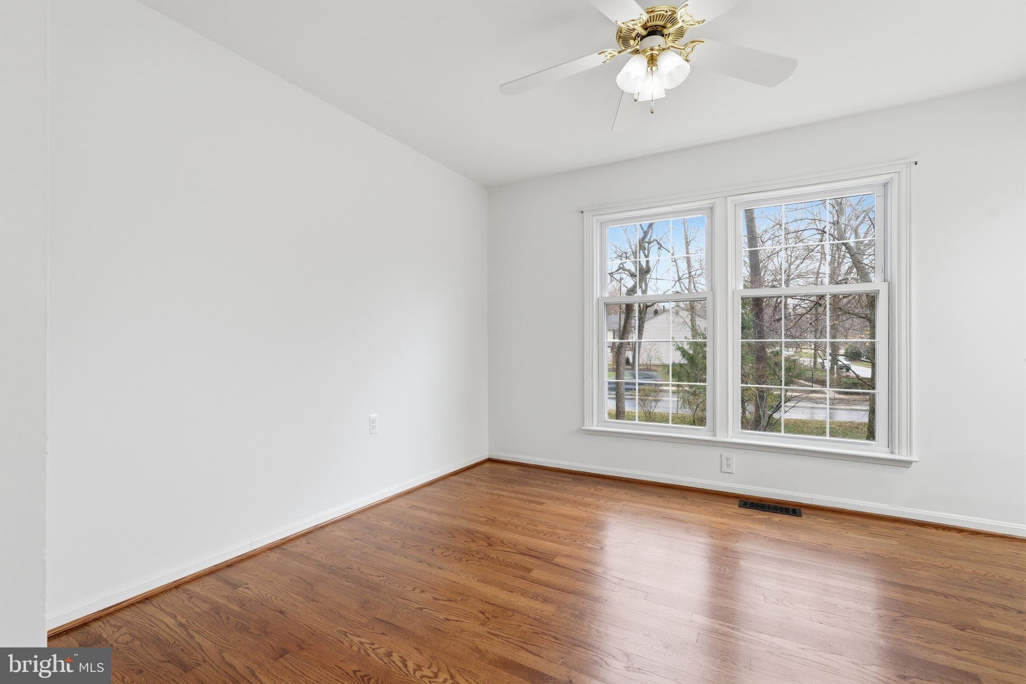 1734 Dana Street Crofton, MD 21114 - Photo 15 of 40 a view of an empty room with wooden floor and a window