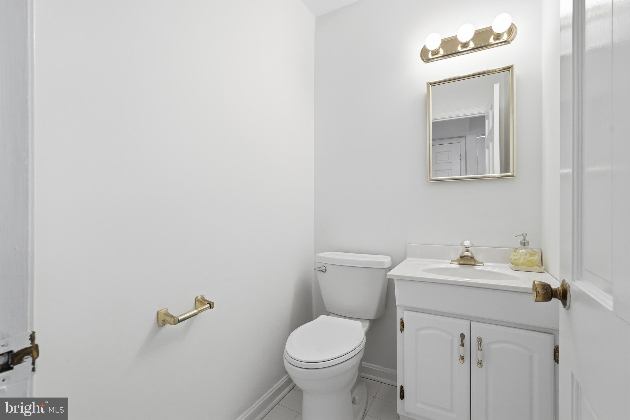 1734 Dana Street Crofton, MD 21114 - Photo 16 of 40 a bathroom with a toilet sink and mirror