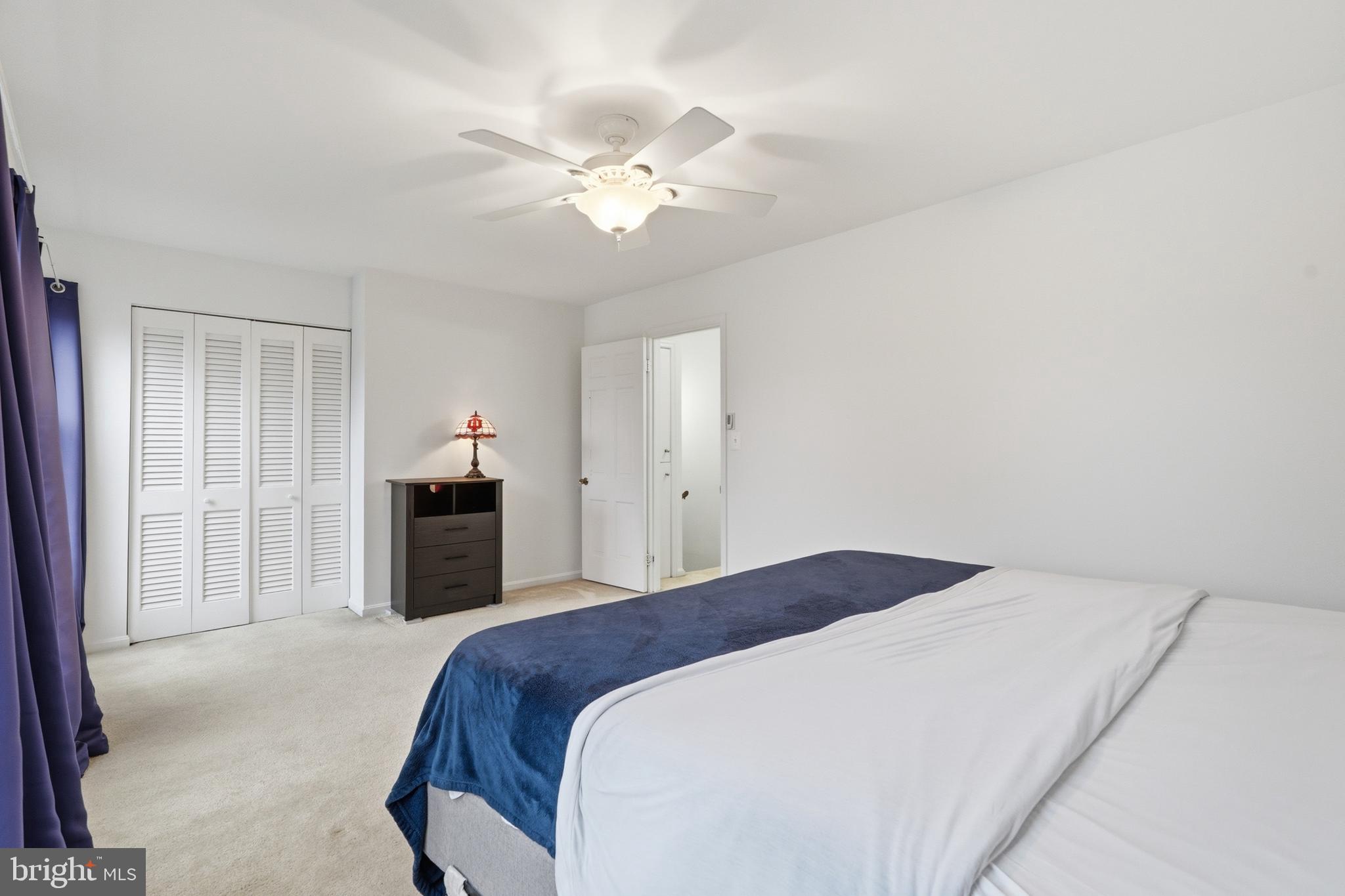 1734 Dana Street Crofton, MD 21114 - Photo 18 of 40 a spacious bedroom with a bed and a chandelier