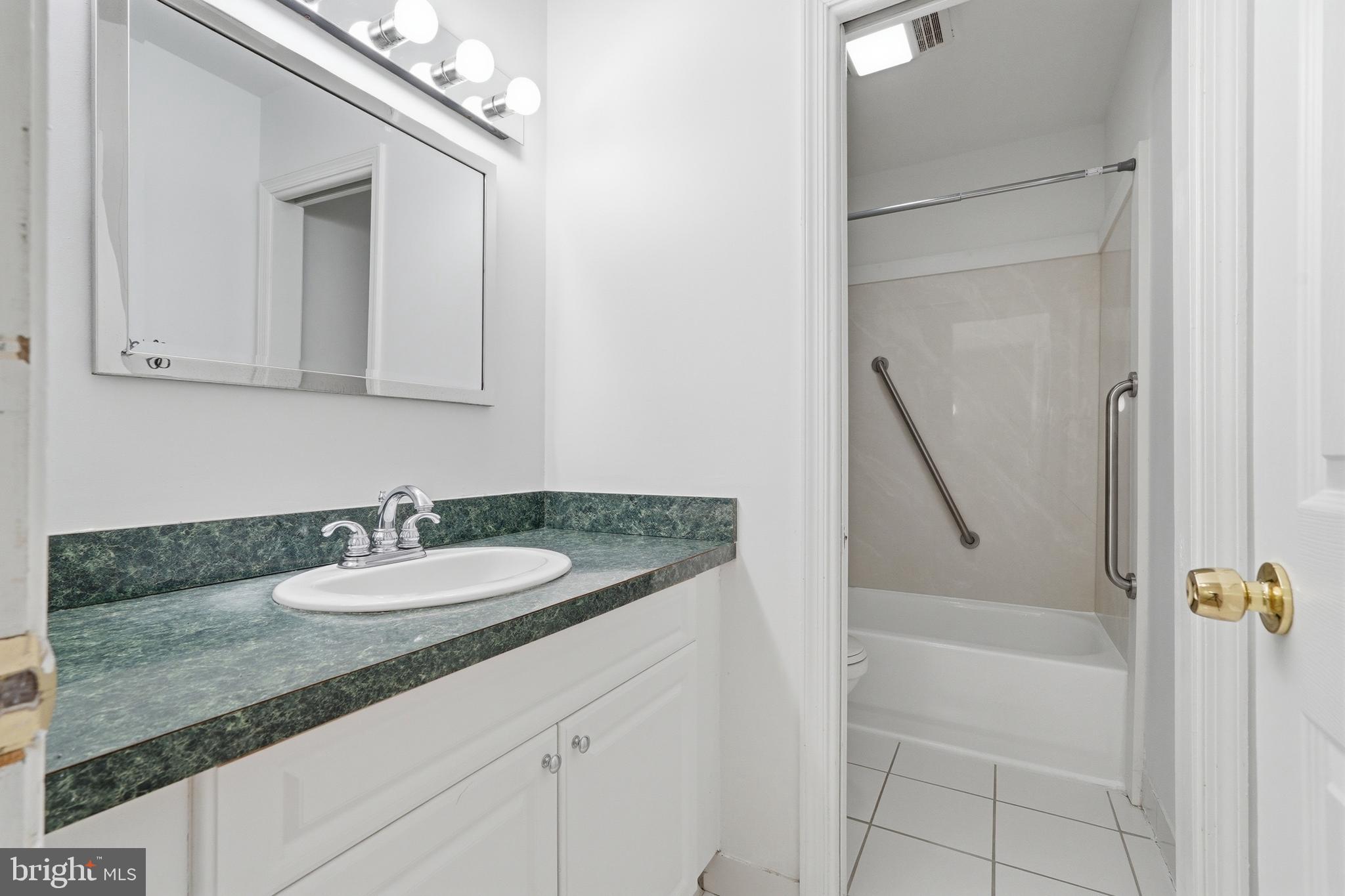 1734 Dana Street Crofton, MD 21114 - Photo 20 of 40 a bathroom with a granite countertop sink and a mirror