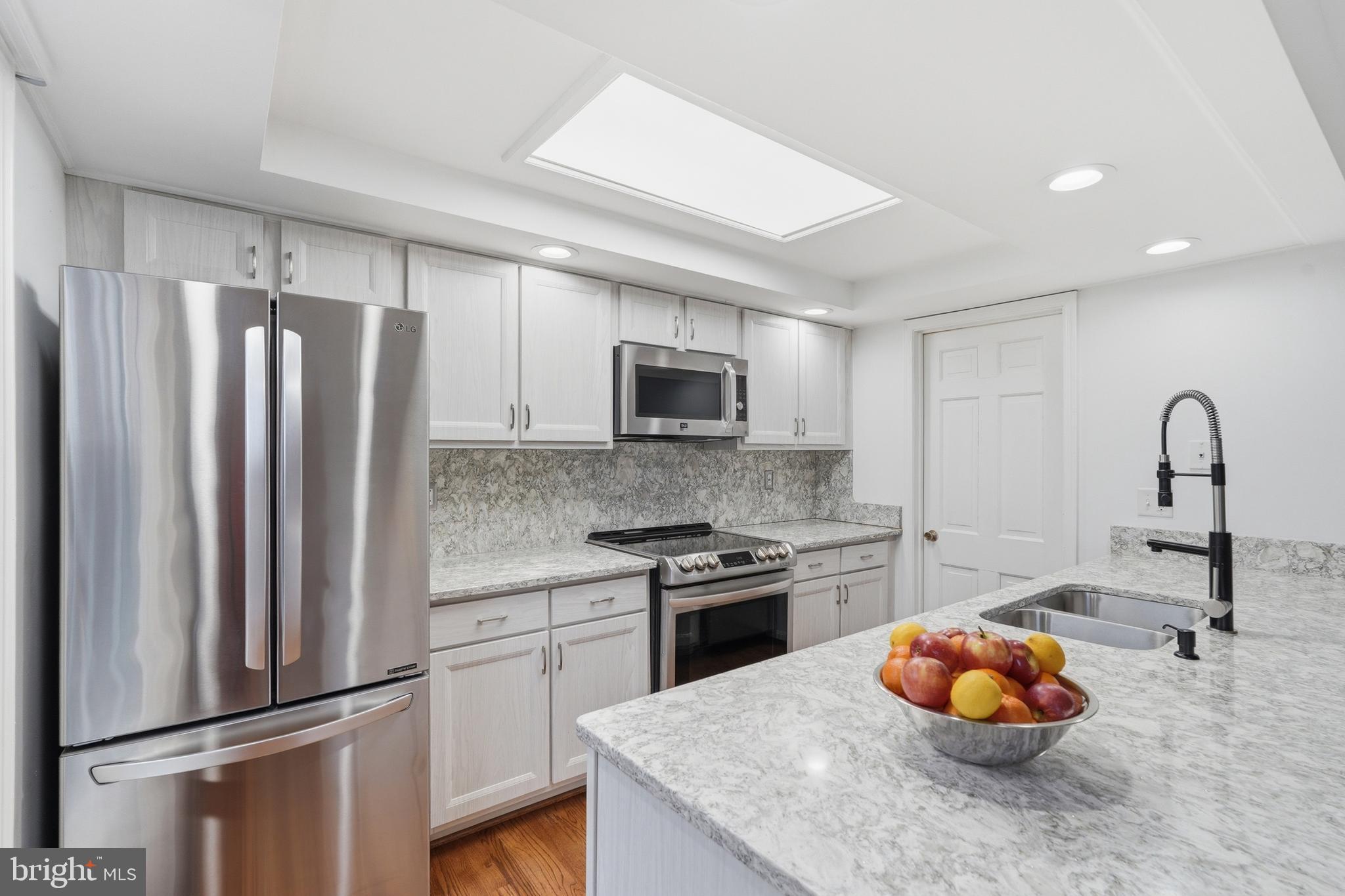 1734 Dana Street Crofton, MD 21114 - Photo 3 of 40 a kitchen with stainless steel appliances granite countertop a refrigerator sink and stove