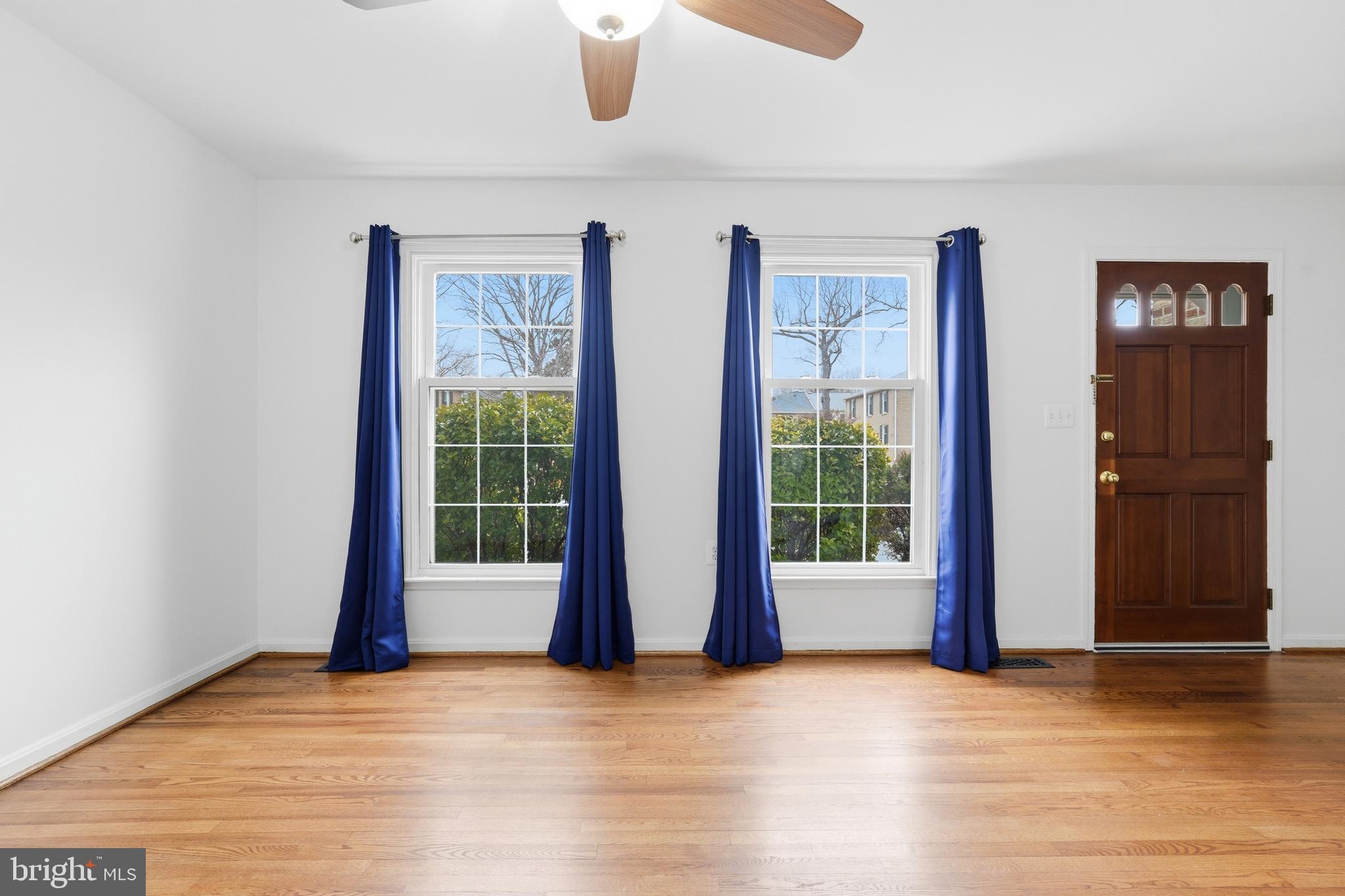 1734 Dana Street Crofton, MD 21114 - Photo 6 of 40 a view of an empty room with wooden floor and windows