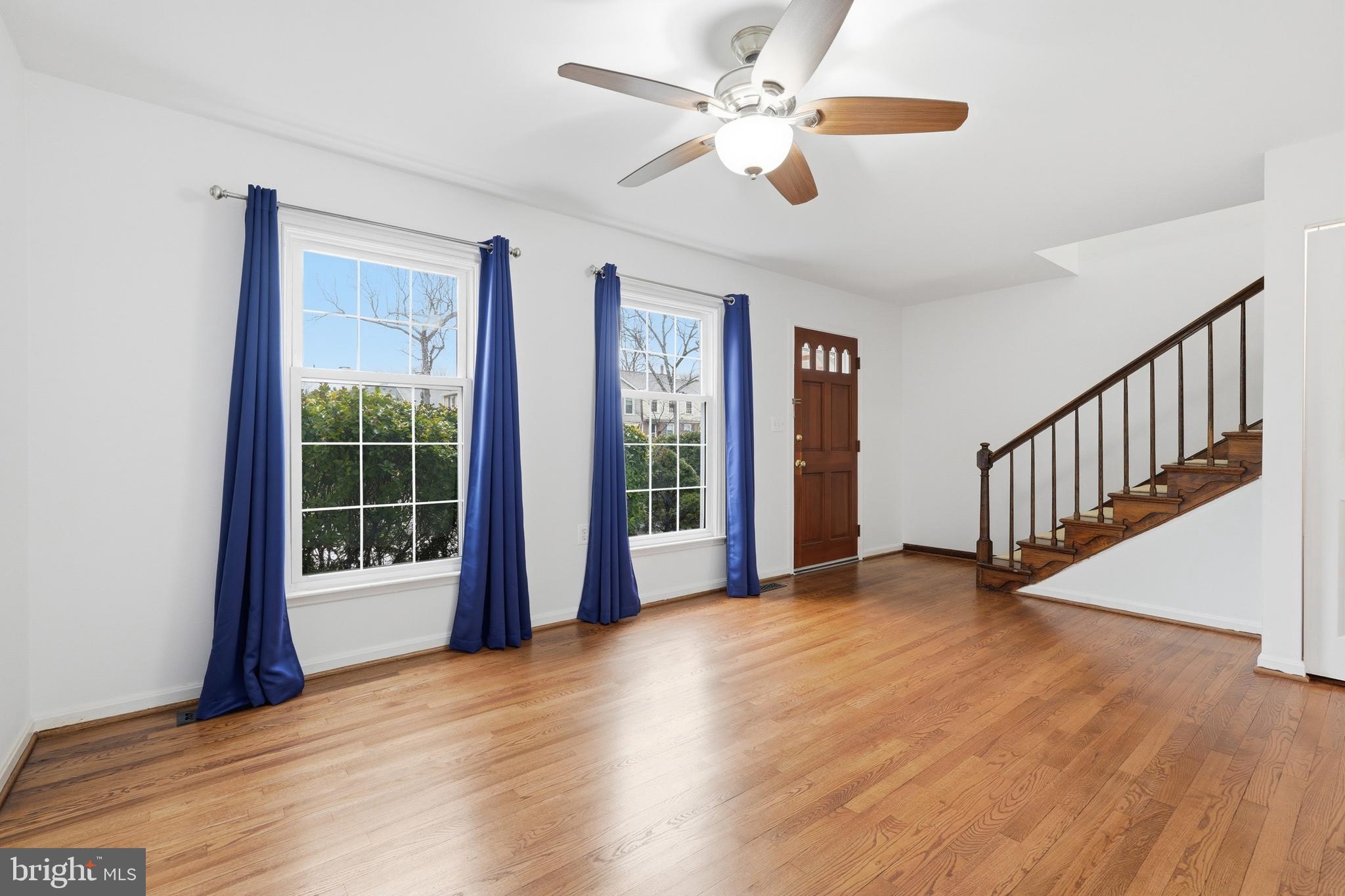 1734 Dana Street Crofton, MD 21114 - Photo 7 of 40 a view of an empty room with a window and wooden floor