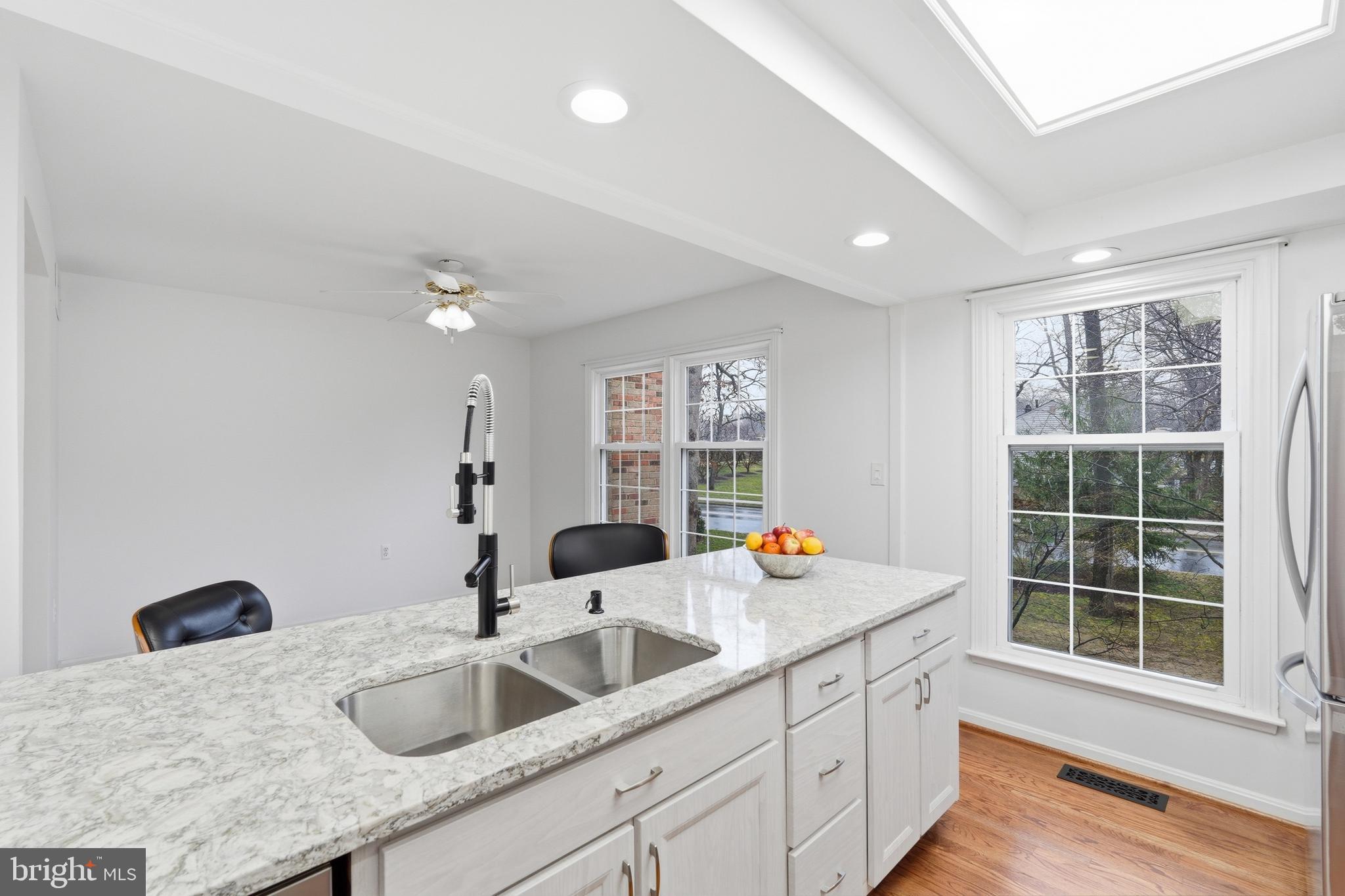 1734 Dana Street Crofton, MD 21114 - Photo 9 of 40 a kitchen with a sink and a large mirror next to a window