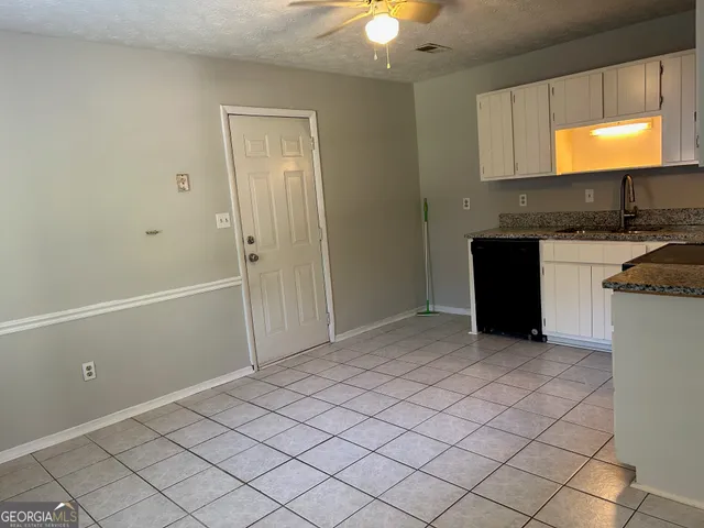 a view of a kitchen with a sink and a window