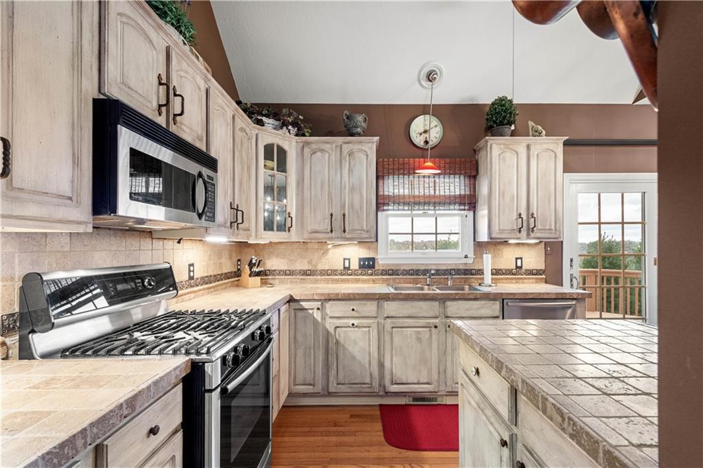 2408 Hilltop Road Presto, PA 15142 - Photo 12 of 42 a kitchen with stainless steel appliances granite countertop a stove sink and cabinets