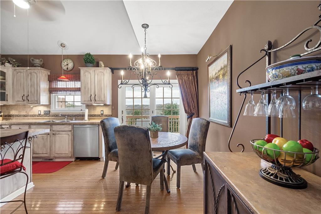 2408 Hilltop Road Presto, PA 15142 - Photo 8 of 42 a dining room with furniture a chandelier and wooden floor