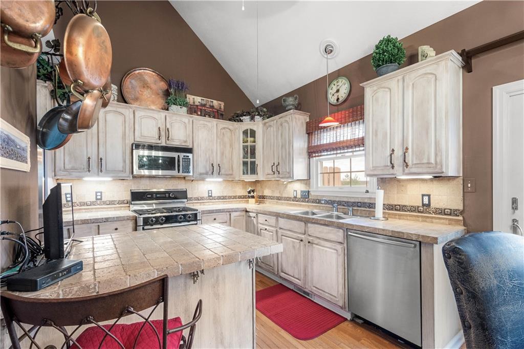 2408 Hilltop Road Presto, PA 15142 - Photo 9 of 42 a kitchen with stainless steel appliances a sink a stove a refrigerator cabinets and a dining table