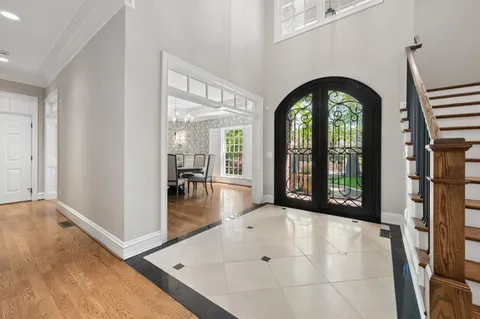 a living room with furniture a rug a fireplace and a window