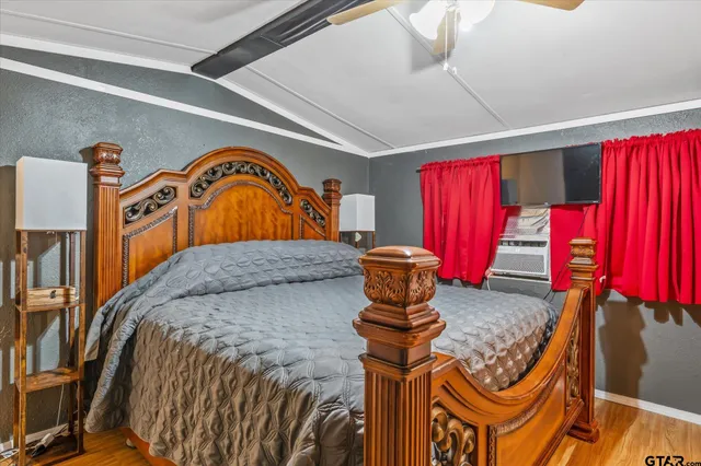 a bed sitting in a bedroom next to a window