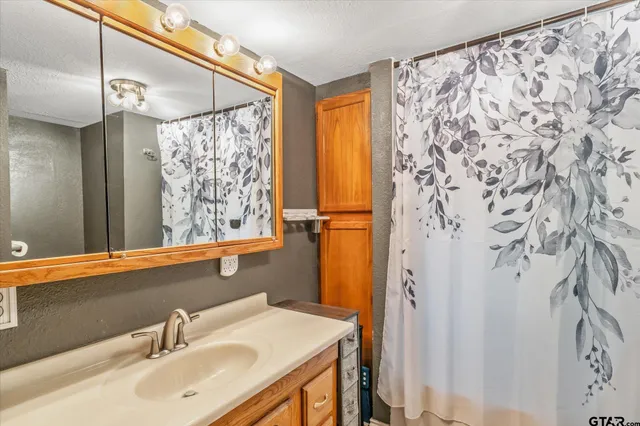 a bathroom with a sink and a mirror