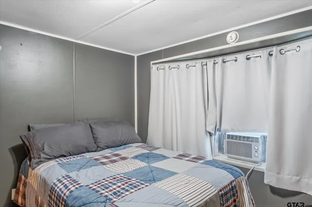 a bedroom with a bed and a window