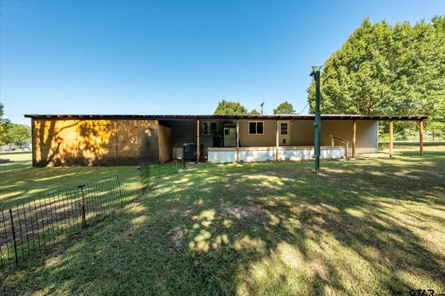 a view of a house with a backyard