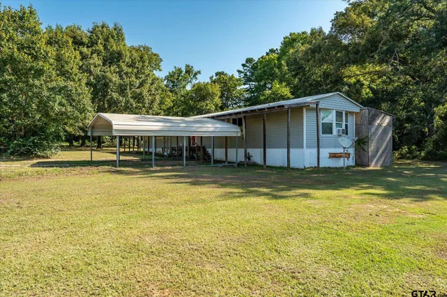 a house with swimming pool in front of it