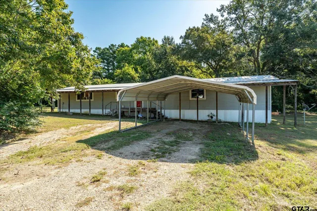 a view of a house with a yard balcony and swimming pool