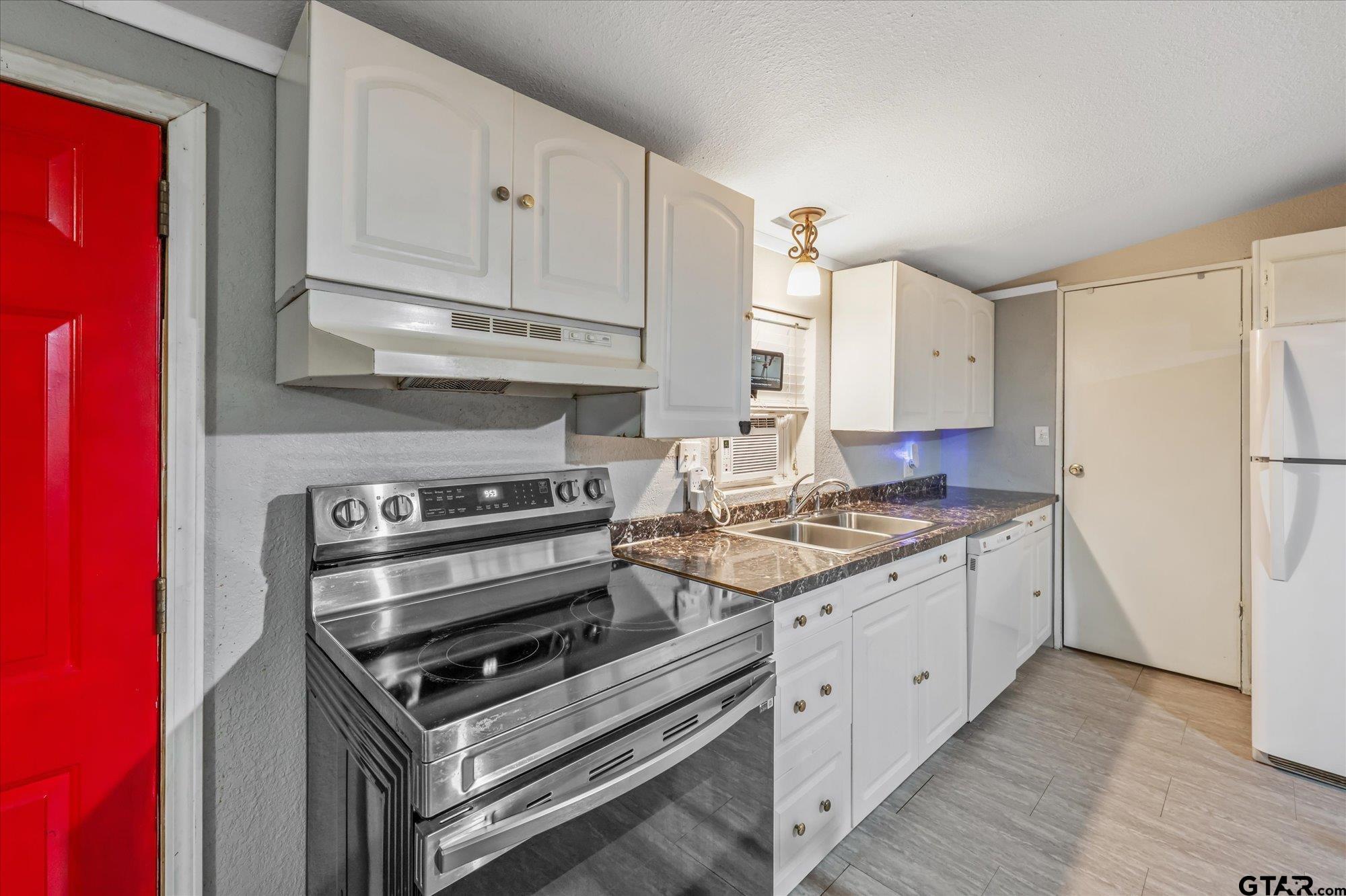 338 Bandera Bullard, TX 75757 - Photo 7 of 26 a kitchen with granite countertop a stove and a refrigerator