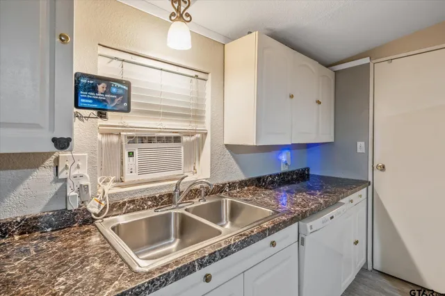 a kitchen with granite countertop a sink and a stove top oven