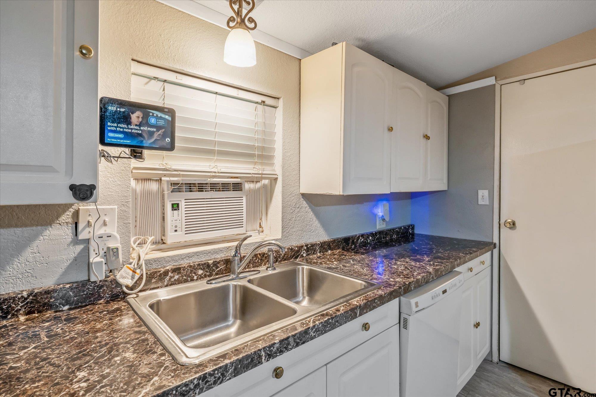 338 Bandera Bullard, TX 75757 - Photo 8 of 26 a kitchen with granite countertop a sink and a stove top oven