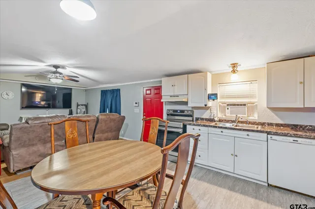 a living room with stainless steel appliances kitchen island granite countertop furniture and a kitchen view