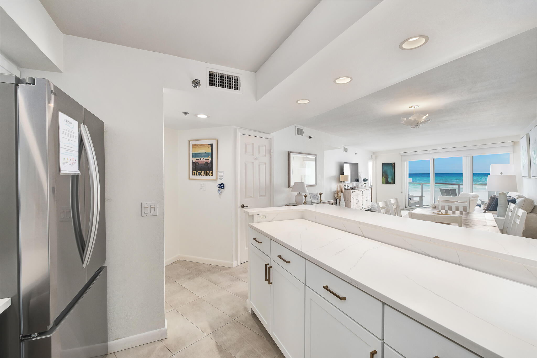 4291 Beachside 2, Unit 4291 Miramar Beach, FL 32550 - Photo 3 of 55 a large white kitchen with stainless steel appliances granite countertop a refrigerator and a sink