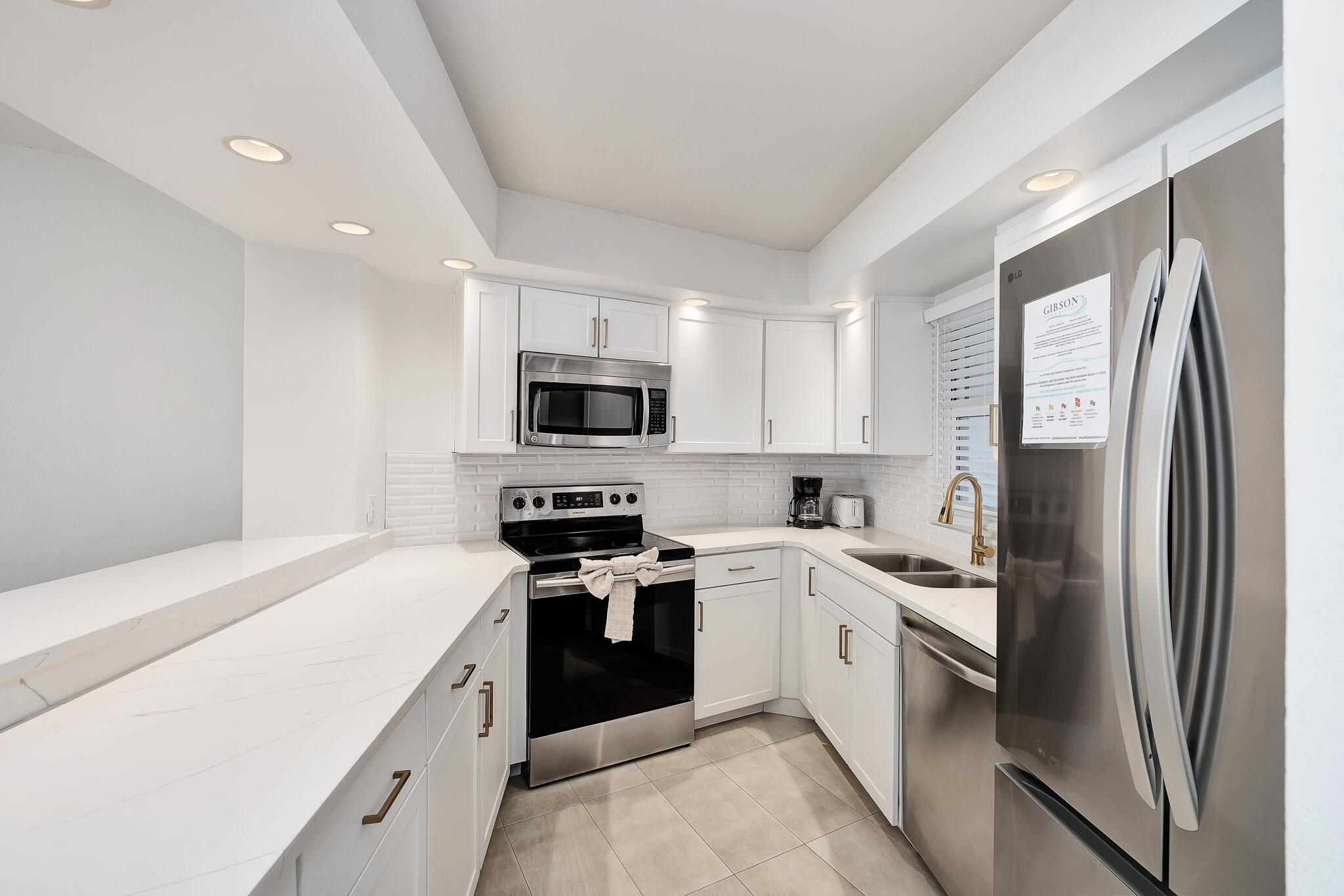 4291 Beachside 2, Unit 4291 Miramar Beach, FL 32550 - Photo 4 of 55 a kitchen with white cabinets and stainless steel appliances