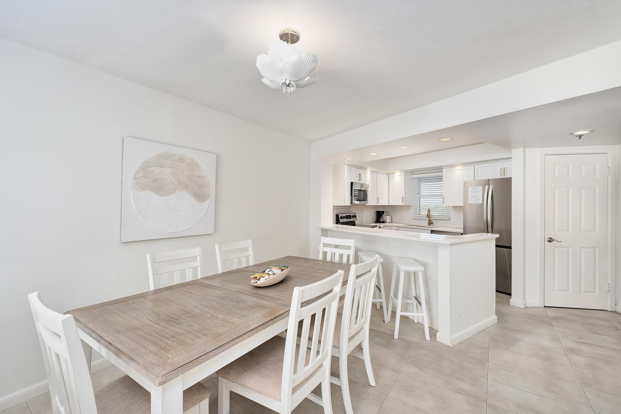 4291 Beachside 2, Unit 4291 Miramar Beach, FL 32550 - Photo 7 of 55 a dining room with a table chairs and kitchen view