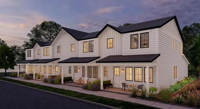 a front view of a house with a yard and outdoor seating