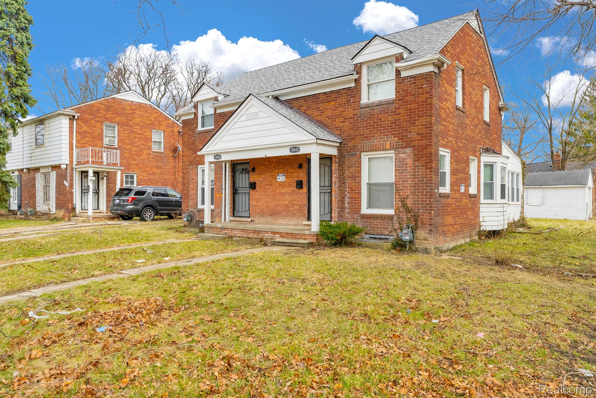 10808 Nottingham Road Detroit, MI 48224 - Photo 22 of 26 Traditional-style home with a front yard, brick siding, and roof with shingles