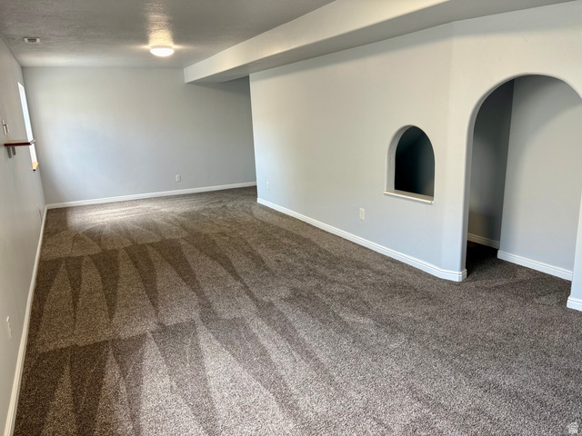 665 West State Road Lehi, UT 84043 - Photo 15 of 30 Spacious room featuring neutral-toned walls, recessed lighting, and a textured carpeted floor