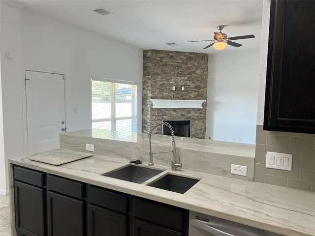 a kitchen with a sink and a stove