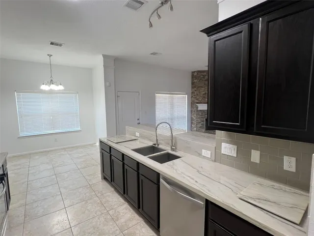 a kitchen with a sink and cabinets