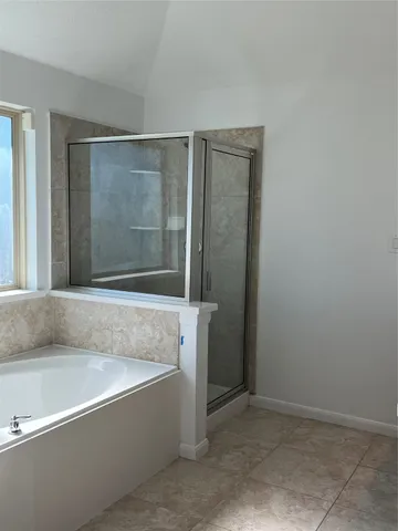 a bathroom with bathtub and shower