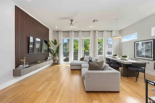 a living room with furniture and large windows