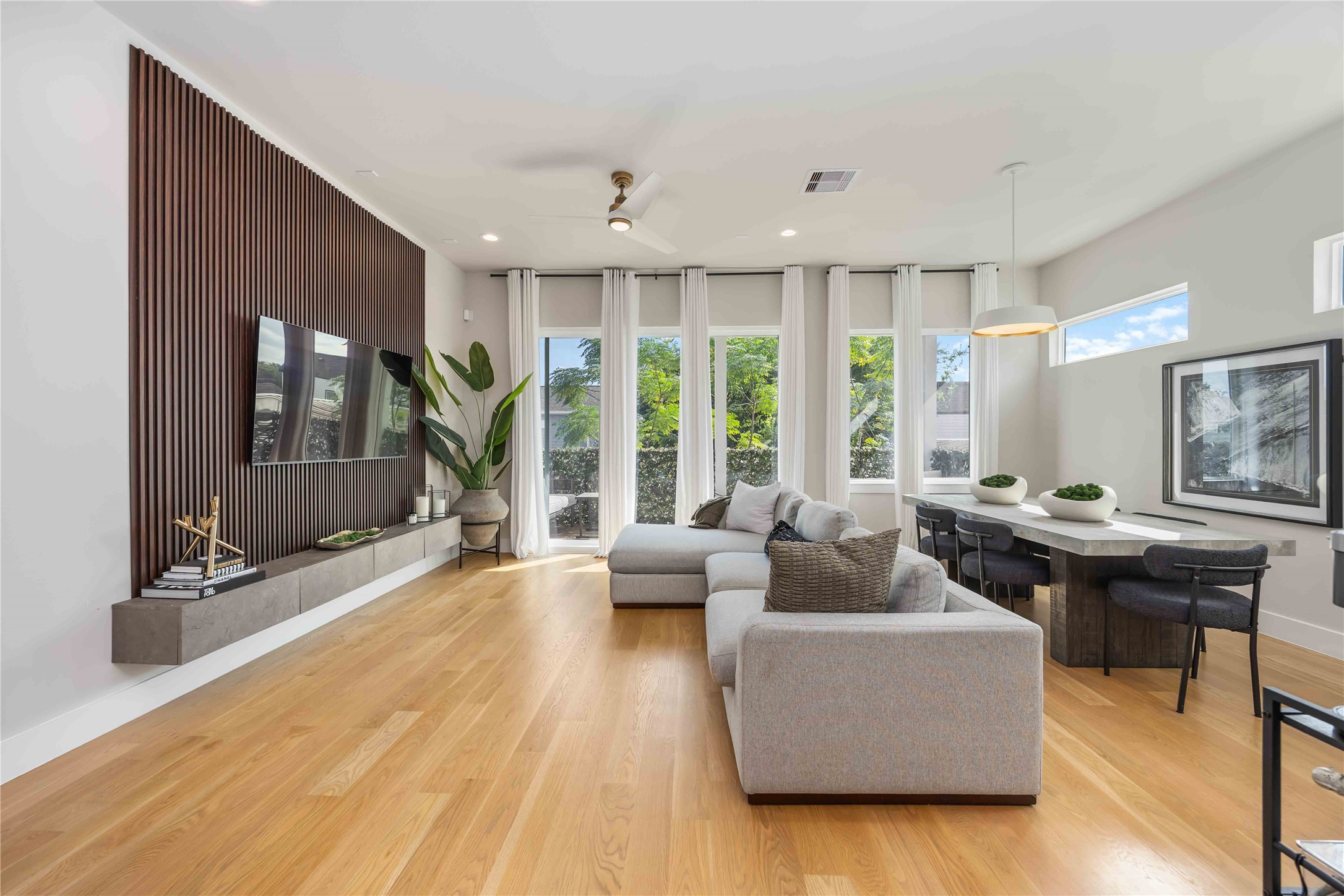 a living room with furniture and large windows