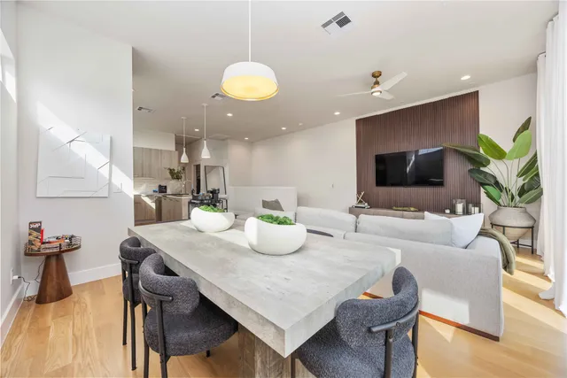 a kitchen with kitchen island a dining table and chairs