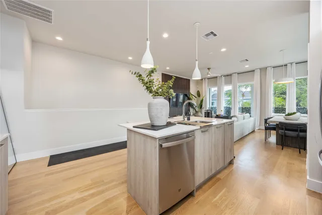 a kitchen with a stove and a wooden floor