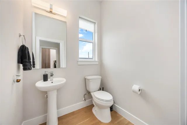 a bathroom with a toilet sink and mirror