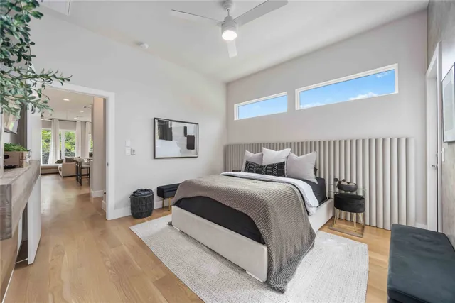 a spacious bedroom with a bed and a chandelier