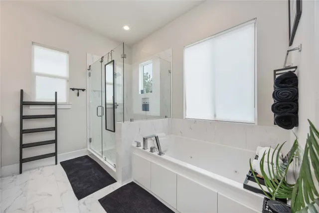 a bathroom with a bathtub and a shower