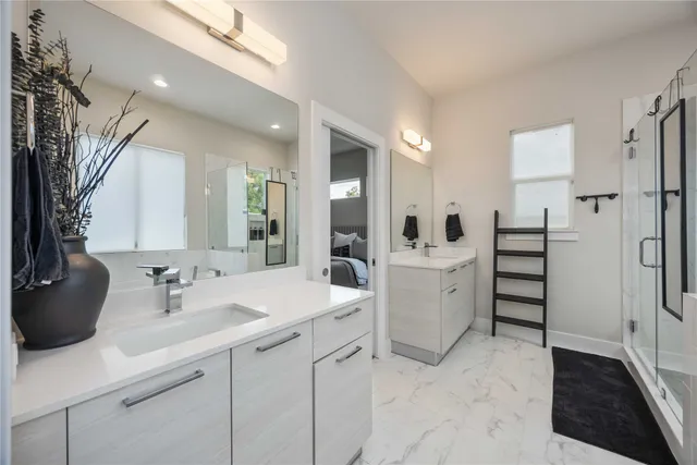 a bathroom with a double vanity sink a toilet and a mirror