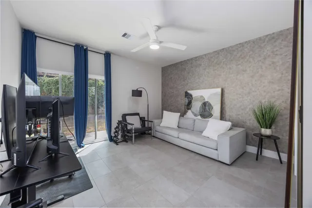 a living room with furniture and a large window
