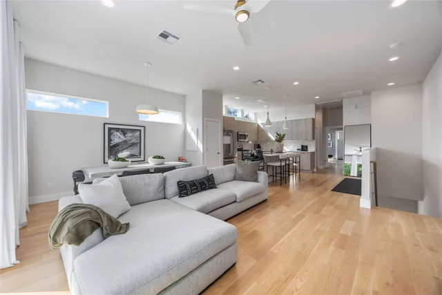a living room with furniture and a view of kitchen