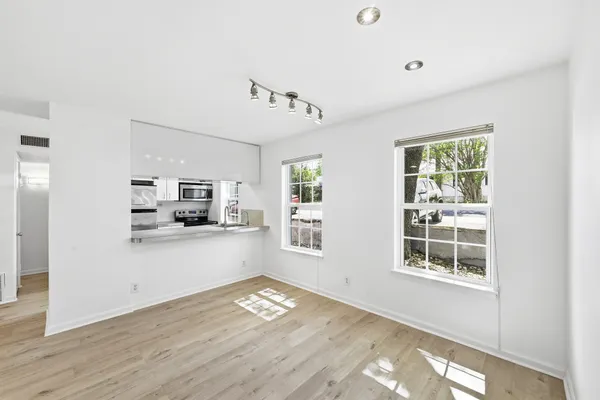 a living room with furniture and wooden floor