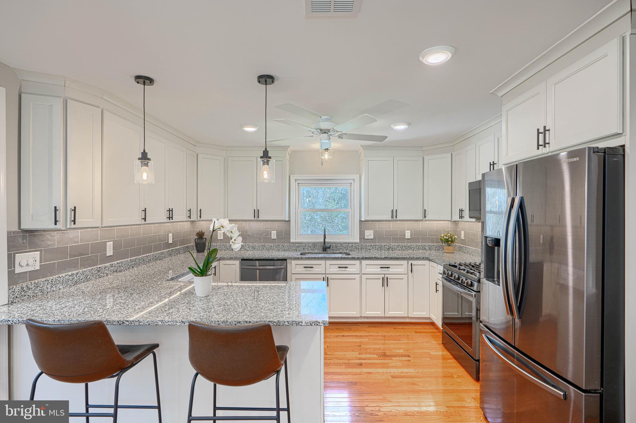 802 Stone Barn Road Towson, MD 21286 - Photo 41 of 104 a kitchen with stainless steel appliances granite countertop a sink a stove a refrigerator and chairs